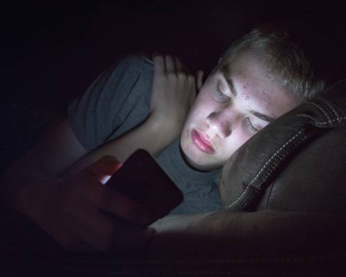 Depressed,Teenage,Boy,Laying,Down,On,A,Couch,With,His